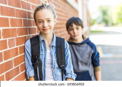 A Portrait Of School 10 Years Boy And Girl Having Fun Outside