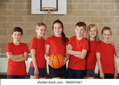 Portrait Of School Basketball Team In Gym