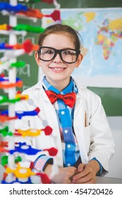 Portrait Of School Girl Assembling Molecule Model For Science Project In Lab At School