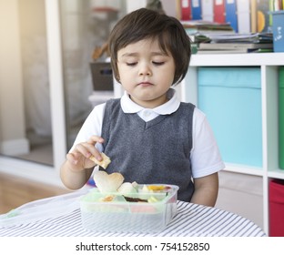 Portrait Of School Kid Eating Lunch With Upset Face, Unhappy Little Boy Not Happy With His Lunch Box, Spoiled Child Concept