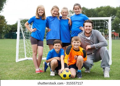 Portrait Of School Soccer Team With Coach