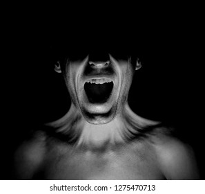 Portrait Of Screaming Adult Caucasian Man In A Dark. Screaming, Strong Pain And Fear Concept. Black And White Shot, Low-key Lighting. Isolated On Black.