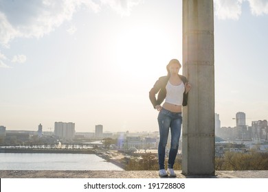 Portrait of seductive woman on rooftop at urban blue sunset sky background Full length girl standing up against city backdrop - Shutterstock ID 191728808