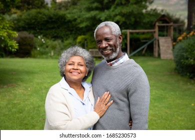 Portrait Of Senior African American Couple In The Garden, Embracing And Smiling. Family Enjoying Time At Home, Lifestyle Concept