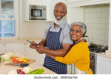 Portrait of senior african american couple cooking together in kitchen using tablet. retreat, retirement and happy senior lifestyle concept. - Powered by Shutterstock