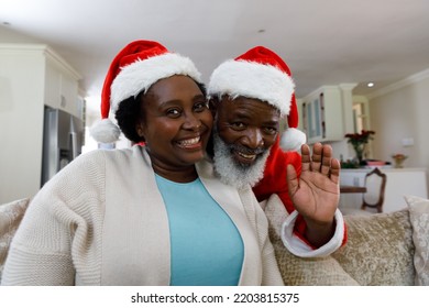 Portrait of senior african american couple smiling and wearing santa hats, looking at camera. quality family time christmas celebration. - Powered by Shutterstock