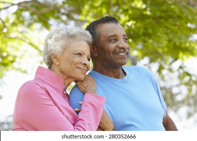 Portrait Of Senior African American Couple Wearing Running Clothing In Park