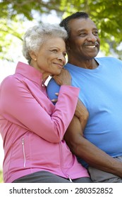 Portrait Of Senior African American Couple Wearing Running Clothing In Park