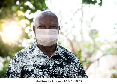 Portrait Of Senior African Man Using Medicine Healthcare Mask For Health Medical Care, Protect Covid-19 And Air Pollution Pm2.5