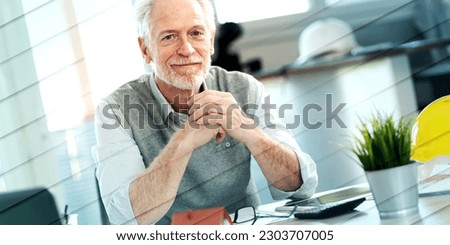 Portrait of senior architect sitting in office and looking at the camera, geometric pattern