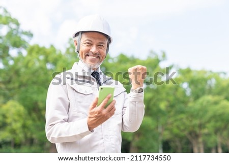portrait of senior asian businessman, construction worker,smart phone,