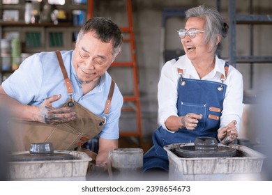 Portrait of a senior Asian couple doing activities together in the pottery workshop. - Powered by Shutterstock