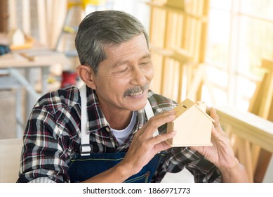 Portrait Senior Asian Elderly Old Man Carpenter Holding Mini Wood House In Concept Diy Furniture House Building In Workshop