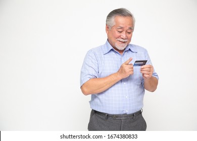 Portrait Of Senior Asian Man Holding Credit Card And Showing On Hand Isolated On White Background