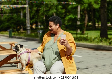 Portrait Of Senior Black Woman Taking Photos With Dog In Outdoor Cafe And Smiling Happily, Copy Space