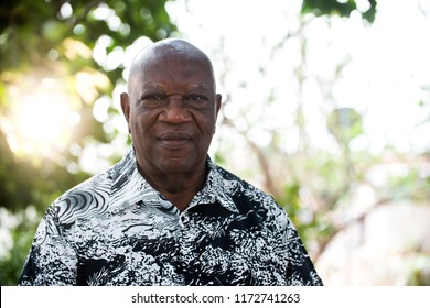 Portrait Of Senior Brazilian Black Man Looking At Camera In Sunset And Serious. Horizontal Shape, Copy Space.