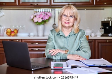 Portrait Of Senior Business Woman Looking At Camera Working At Home With Laptop