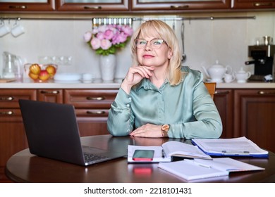 Portrait Of Senior Business Woman Looking At Camera Working At Home With Laptop