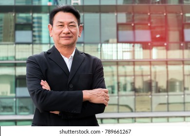 Portrait Senior Businessman On Urban Background