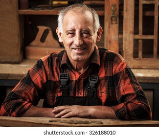 Portrait Of Senior Carpenter In His Workshop.