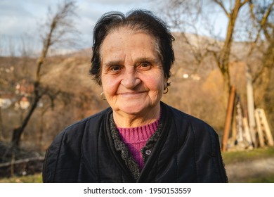 Portrait of senior caucasian woman in nature standing in spring or autumn day - close up of cheerful female pensioner farmer standing in rural nature on farm looking to camera - real people concept - Powered by Shutterstock