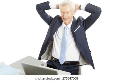 Portrait Of Senior Chief Financial Officer Sitting In Front Of Laptop At Desk While Sit Back And Relaxing. Isolated On White Background. 