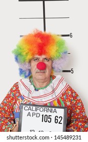 Portrait of senior clown posing for mug shot