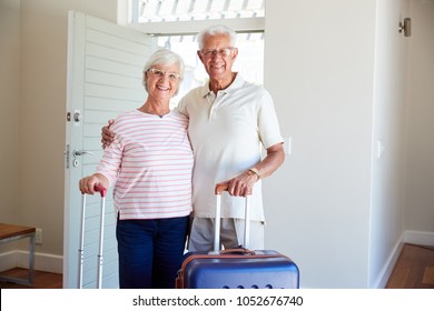 Portrait Of Senior Couple Arriving At Summer Vacation Rental - Powered by Shutterstock