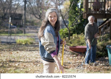 Portrait Of A Senior Couple Doing Yard Work