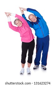 Portrait Of A Senior Couple Exercising On White Background