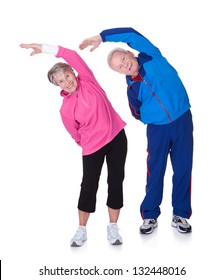 Portrait Of A Senior Couple Exercising On White Background