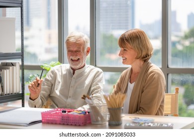 Portrait Of Senior Couple Painting On A Canvas In Living Room, Older Man And Woman Drawing Together On A Canvas At Art Studio, Happy Retirement Concepts