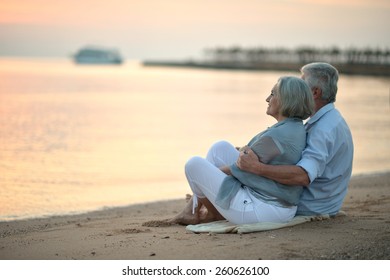 Portrait of a senior couple at sea at sunset - Powered by Shutterstock