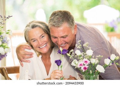 Portrait Senior Couple Smelling Flowers