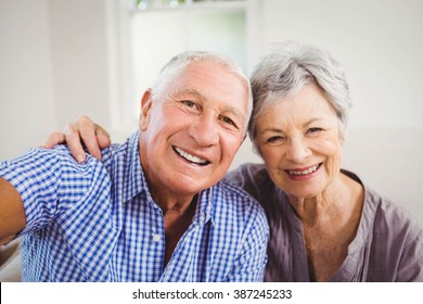 Portrait Of Senior Couple Smiling In Living Room