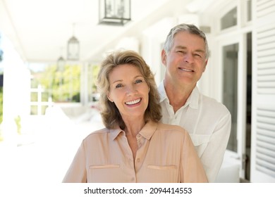 Portrait Of Senior Couple Smiling On Porch