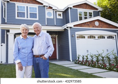 Portrait Of Senior Couple Standing Outside House