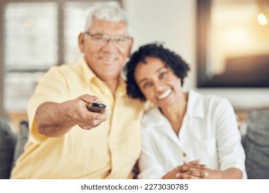 Portrait of senior couple watching tv on sofa with comedy show, film or movies at home together with love and hug. Biracial people or woman with elderly partner watch television and relaxing on couch - Powered by Shutterstock