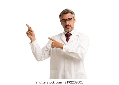 Portrait Of Senior Doctor Pointing Up Showing On Copy Space Looking At Camera. Isolated On White Background