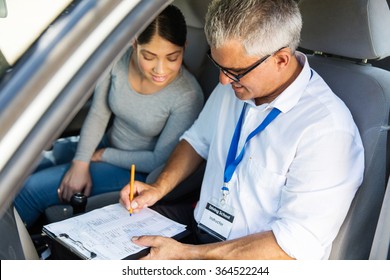 Portrait Of Senior Driving Instructor And Student Driver During Lesson