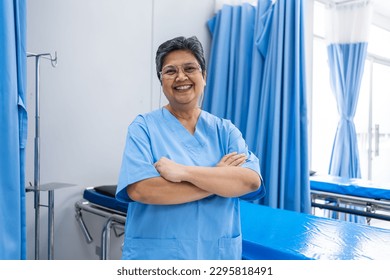 Portrait of Senior elderly female nurse standing in the hospital ward. Attractive mature older therapist female doctor smile and looking at camera after success work from treatment in medical clinic. - Powered by Shutterstock