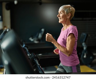 Portrait of a senior elderly woman exercising in a gym, running using threadmill machine equipment, healthy lifestyle and cardio exercise at fitness club concepts, vitality and active senior - Powered by Shutterstock