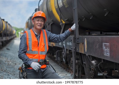 Portrait Senior Engineer Smile And Look At Camera On Freight Train Oil Transport On Background. Portrait Worker On Oil Tank On Background.