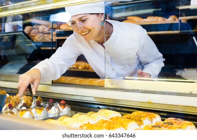 Portrait of senior european baker with sweet cakes in local confectionery - Powered by Shutterstock