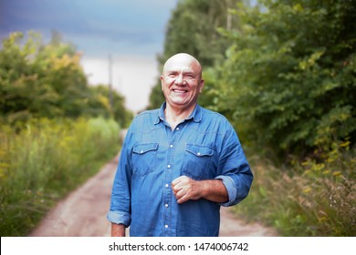 Portrait of  senior farmer in   denim shirt in   village. - Shutterstock ID 1474006742