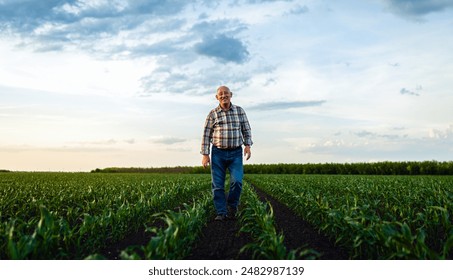 Portrait of senior farmer standing in corn field looking at camera at sunset. - Powered by Shutterstock