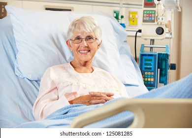 Portrait Of Senior Female Patient Relaxing In Hospital Bed