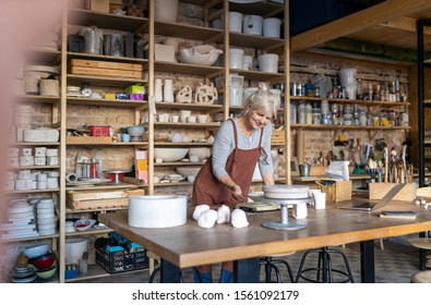 Portrait of senior female pottery artist in her art studio
 - Powered by Shutterstock