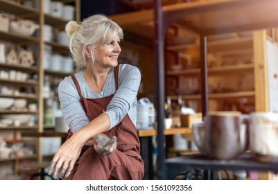 Portrait of senior female pottery artist in her art studio
 - Powered by Shutterstock