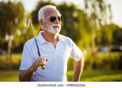 Portrait Of Senior Golfer Standing On Court.